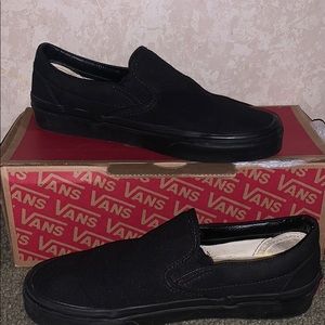 All black slip on vans